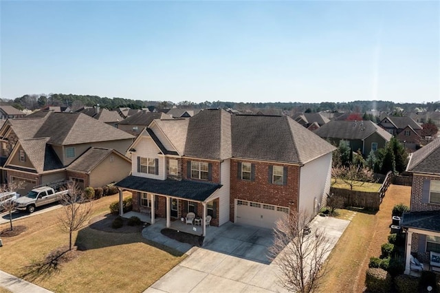 view of front of house featuring a residential view, covered porch, concrete driveway, a garage, and brick siding