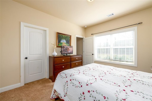 bedroom featuring light colored carpet, visible vents, and baseboards