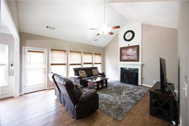 living room featuring a wealth of natural light, high vaulted ceiling, ceiling fan, and hardwood / wood-style flooring