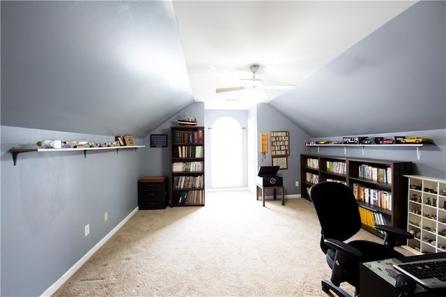 carpeted office with ceiling fan and vaulted ceiling