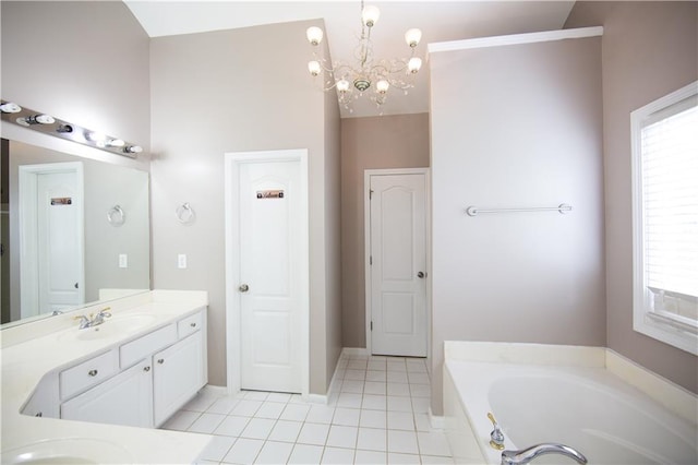 bathroom with a tub, a notable chandelier, vanity, and tile patterned floors