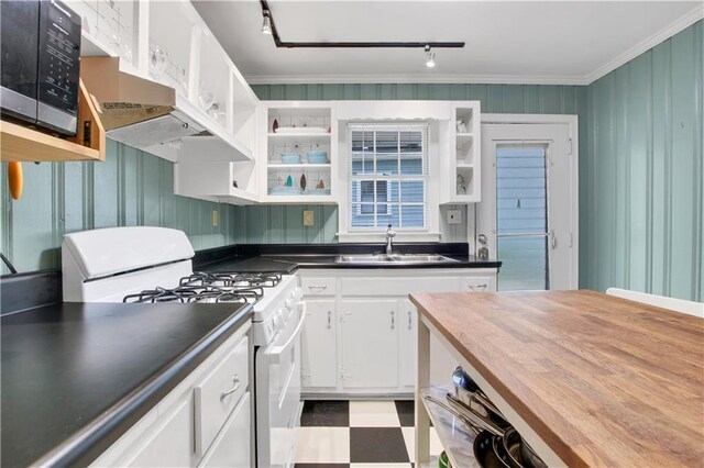 kitchen featuring white gas range oven, ornamental molding, white cabinetry, open shelves, and a sink