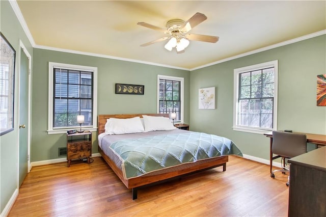 bedroom with crown molding and wood finished floors