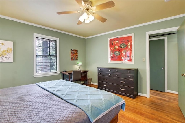 bedroom with light wood-type flooring, crown molding, baseboards, and a ceiling fan