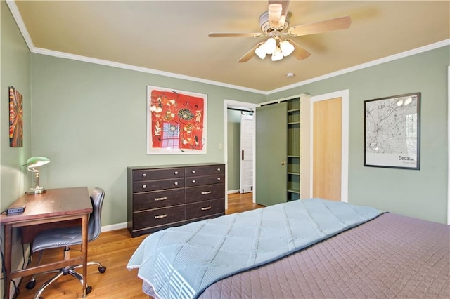 bedroom with ceiling fan, baseboards, crown molding, and wood finished floors
