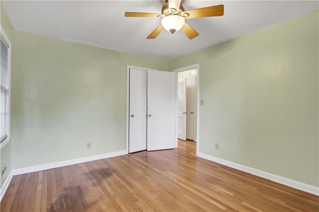 unfurnished bedroom with baseboards, a ceiling fan, and light wood-style floors