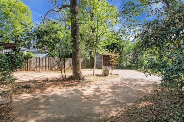 view of yard with an outdoor structure and fence