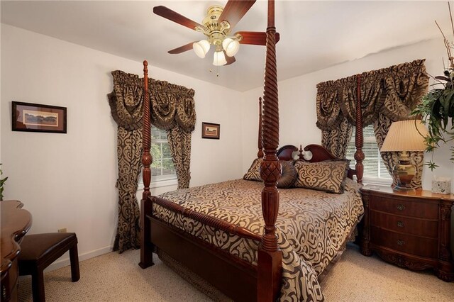 bedroom featuring light colored carpet and ceiling fan