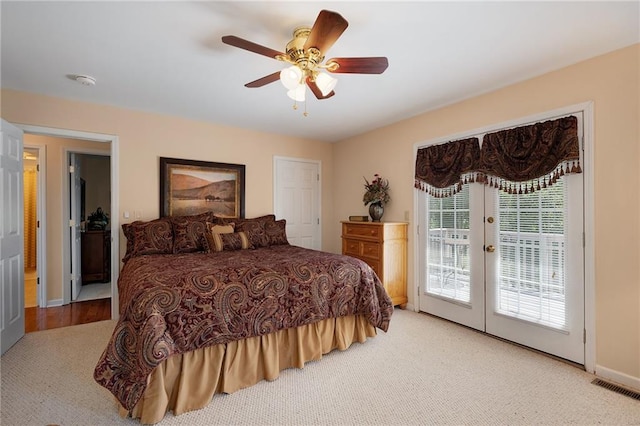 carpeted bedroom featuring french doors, access to outside, and ceiling fan