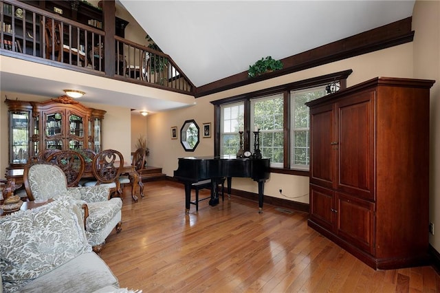 interior space with light hardwood / wood-style flooring and a towering ceiling