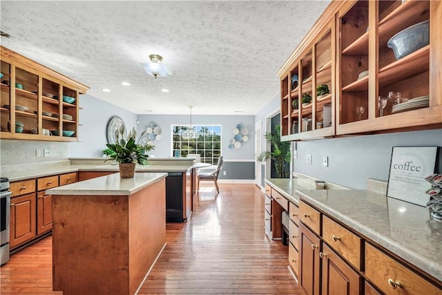 70 Lake Charles Xing, Covington, GA 30016 - kitchen featuring a kitchen island, hardwood / wood-style flooring, open shelves, brown cabinetry, and a textured ceiling