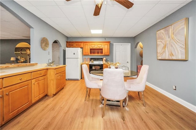 70 Lake Charles Xing, Covington, GA 30016 - dining space with arched walkways, a drop ceiling, light wood finished floors, baseboards, and ceiling fan