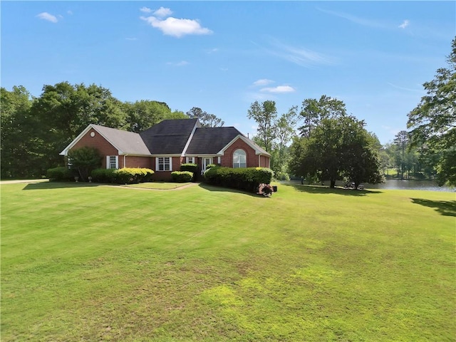 70 Lake Charles Xing, Covington, GA 30016 - view of front facade with a front yard, brick siding, and a water view