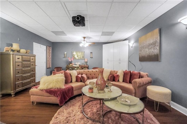 70 Lake Charles Xing, Covington, GA 30016 - living area with dark wood-type flooring, a ceiling fan, and baseboards