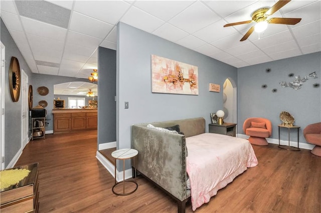 70 Lake Charles Xing, Covington, GA 30016 - living area with arched walkways, a ceiling fan, a paneled ceiling, wood finished floors, and baseboards