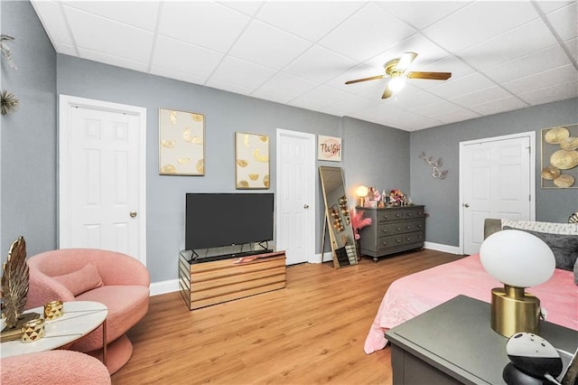 70 Lake Charles Xing, Covington, GA 30016 - bedroom featuring a paneled ceiling, light wood-style floors, baseboards, and a ceiling fan
