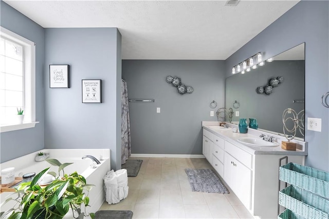 70 Lake Charles Xing, Covington, GA 30016 - bathroom with a bath, double vanity, a textured ceiling, and tile patterned floors