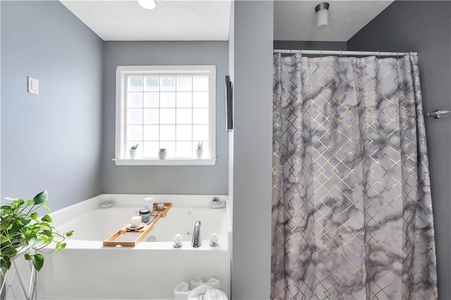 70 Lake Charles Xing, Covington, GA 30016 - full bath featuring a garden tub, curtained shower, and a textured ceiling
