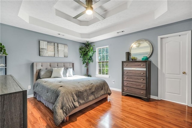 70 Lake Charles Xing, Covington, GA 30016 - bedroom featuring a raised ceiling, wood finished floors, baseboards, and a ceiling fan