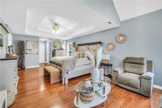 70 Lake Charles Xing, Covington, GA 30016 - bedroom featuring a raised ceiling, wood finished floors, baseboards, and a ceiling fan