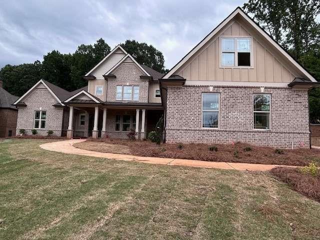 4563 Fawn Path, Gainesville, GA 30506 - craftsman inspired home with brick siding, board and batten siding, a front yard, and a porch
