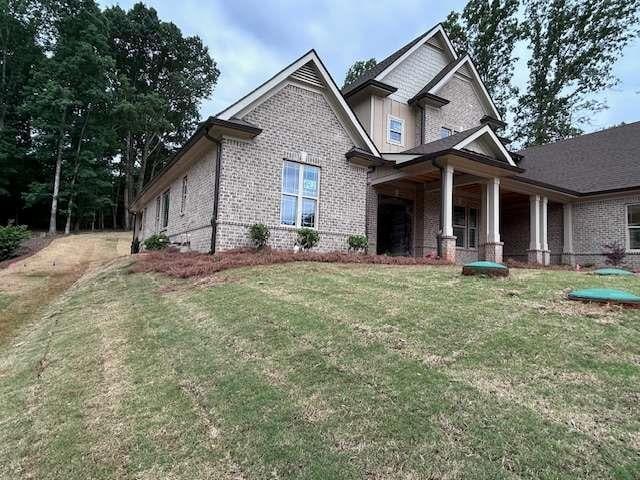 4563 Fawn Path, Gainesville, GA 30506 - craftsman-style home featuring brick siding, covered porch, and a front lawn