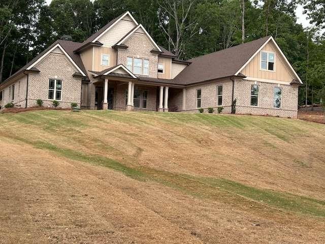 4563 Fawn Path, Gainesville, GA 30506 - craftsman inspired home with brick siding, a front yard, covered porch, and board and batten siding
