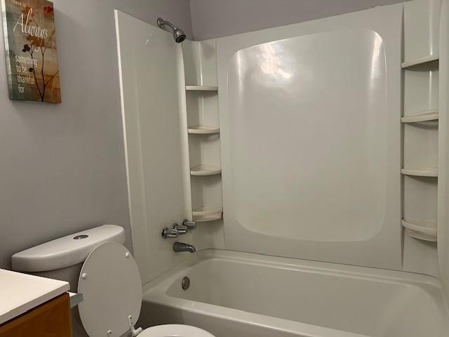 full bathroom with shower / bath combination, vanity, and toilet