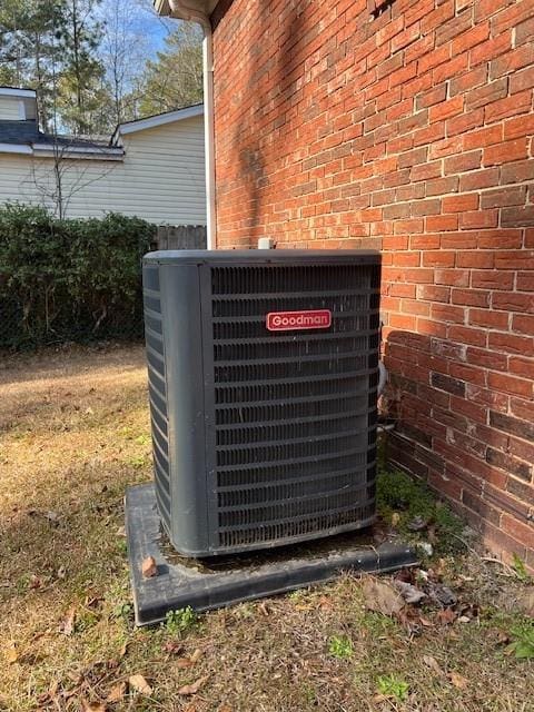 exterior details featuring central air condition unit and brick siding