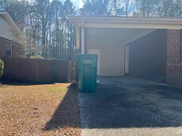 view of property exterior with fence and brick siding