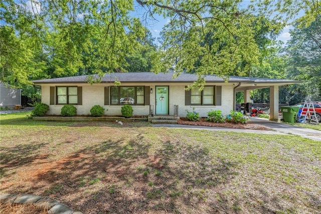 312 Glen Iris Dr, Monroe, GA 30655 - ranch-style home featuring driveway, an attached carport, brick siding, and a front yard