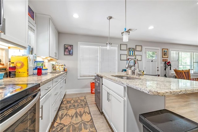 312 Glen Iris Dr, Monroe, GA 30655 - kitchen with dishwasher, white cabinets, recessed lighting, light stone countertops, and decorative light fixtures