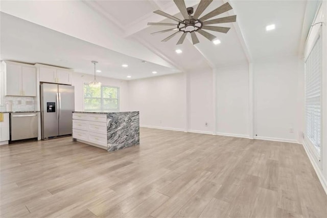 unfurnished living room with lofted ceiling with beams and light wood-type flooring