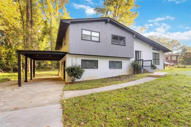 view of side of home featuring a lawn and a carport