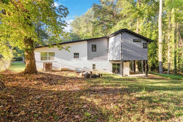 rear view of property with a yard