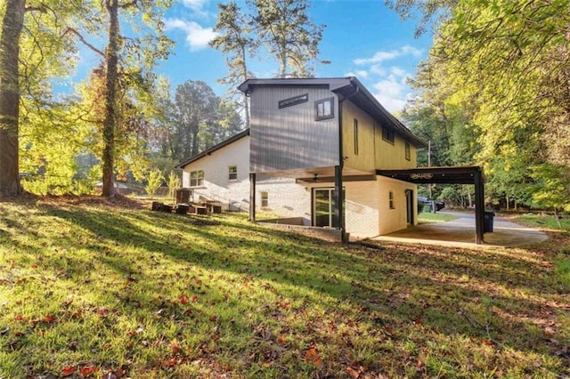 rear view of house featuring a patio and a yard