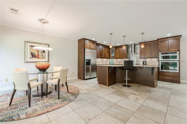 535 Brickleberry Ln, Roswell, GA 30075 - kitchen with appliances with stainless steel finishes, decorative backsplash, a kitchen island, wall chimney exhaust hood, and a kitchen breakfast bar
