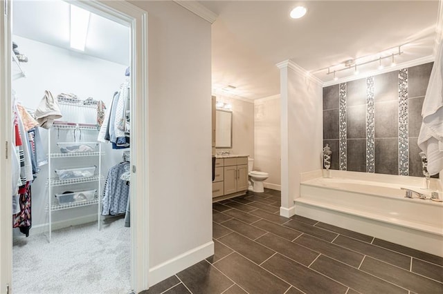 535 Brickleberry Ln, Roswell, GA 30075 - bathroom featuring ornamental molding, a garden tub, vanity, a spacious closet, and recessed lighting