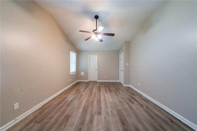 empty room with baseboards, a ceiling fan, and wood finished floors