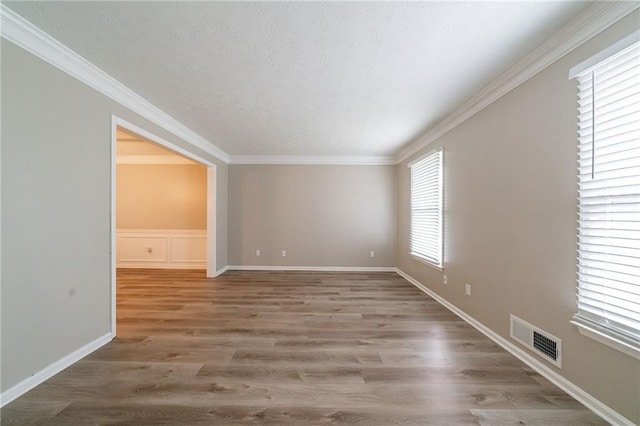 unfurnished dining area with wainscoting, wood finished floors, and a wealth of natural light