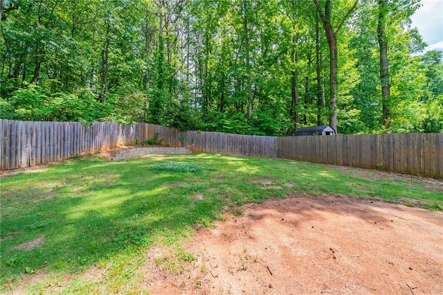 rear view of property featuring a yard, a wooden deck, and a fenced backyard