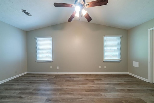 spare room featuring visible vents, a wealth of natural light, and vaulted ceiling