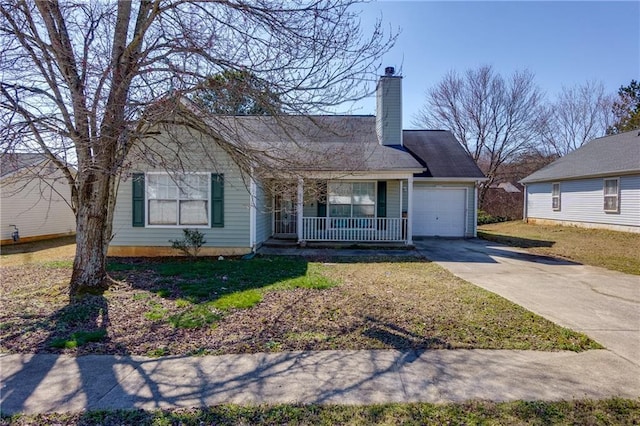 view of front of house with a chimney, covered porch, concrete driveway, a garage, and a front lawn