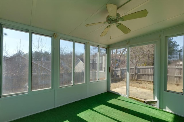 unfurnished sunroom with a ceiling fan