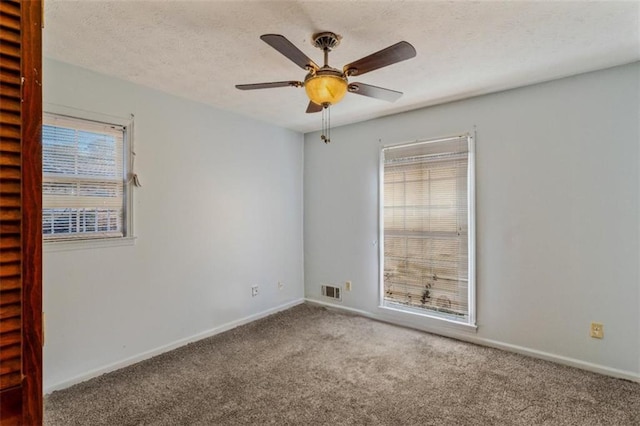 carpeted spare room with ceiling fan