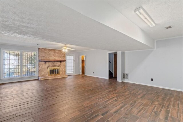 kitchen with light wood-type flooring, a textured ceiling, stainless steel appliances, ventilation hood, and sink