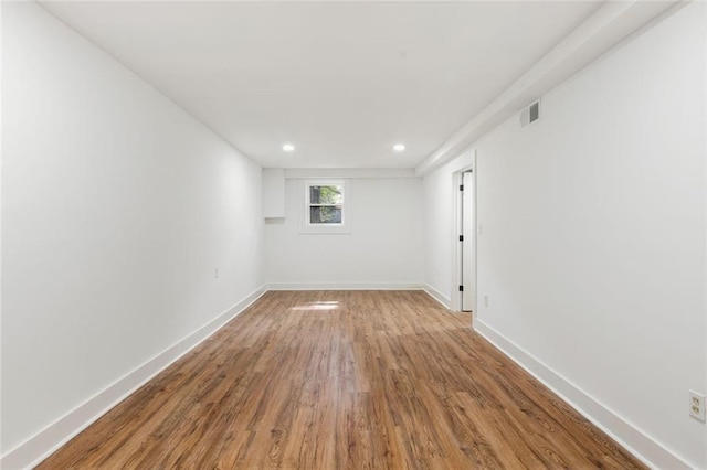 spare room with hardwood / wood-style floors