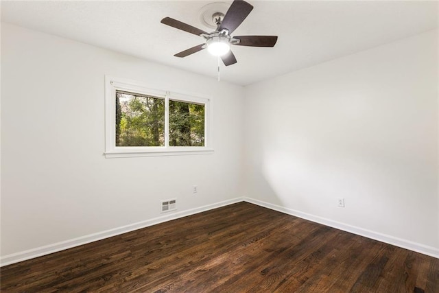 empty room with ceiling fan and dark hardwood / wood-style flooring