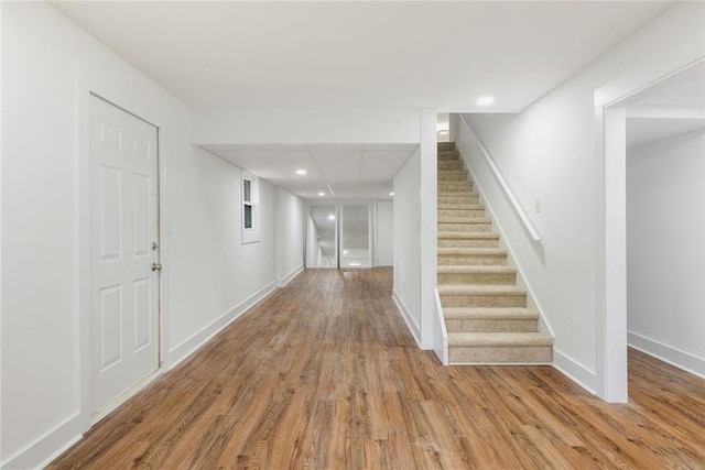 hall with hardwood / wood-style floors