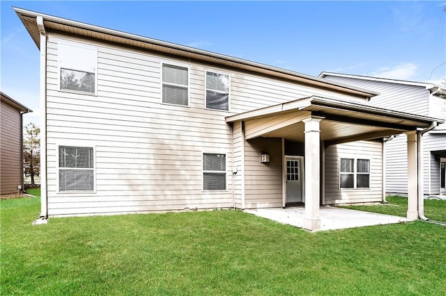 rear view of house with a patio area and a lawn